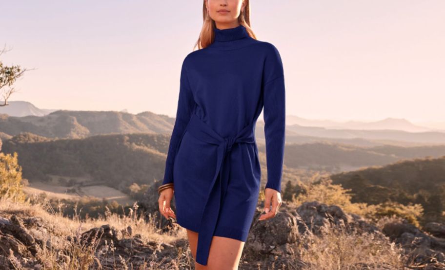 a woman in a navy blue tie waist mini dress 