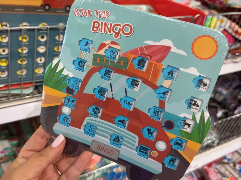one target road trip bingo card being held in front of a store rack