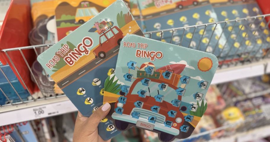 two target road trip bingo cards being held in front of a rack