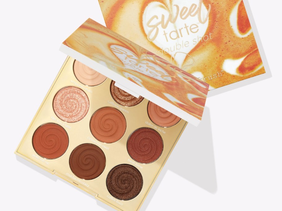 Tarte eyeshadow palette open showing colors, closed one behind it