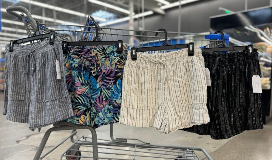 4 pair of time and tru womens linen shorts hanging on a shopping cart in a walmart store
