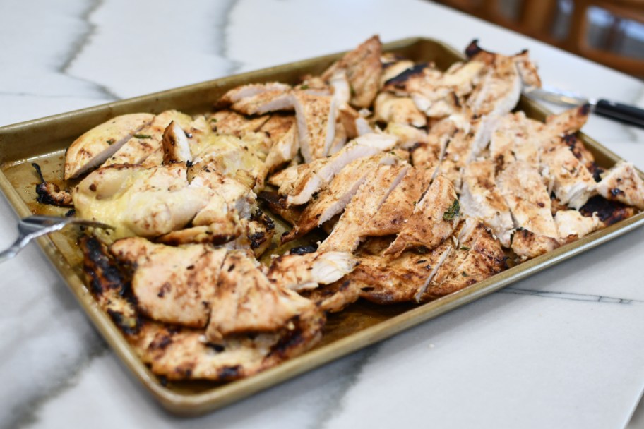 tray with grilled sliced chicken on top