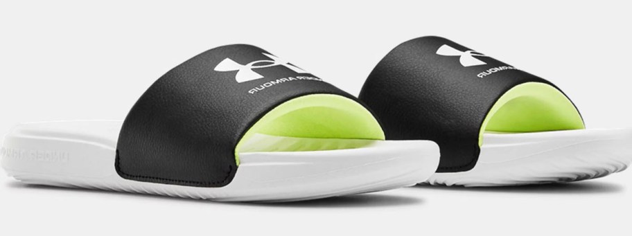 black, white and lime green under armour slides