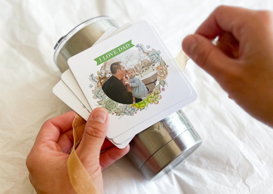 hands wrapping photo coaster on yeti mug