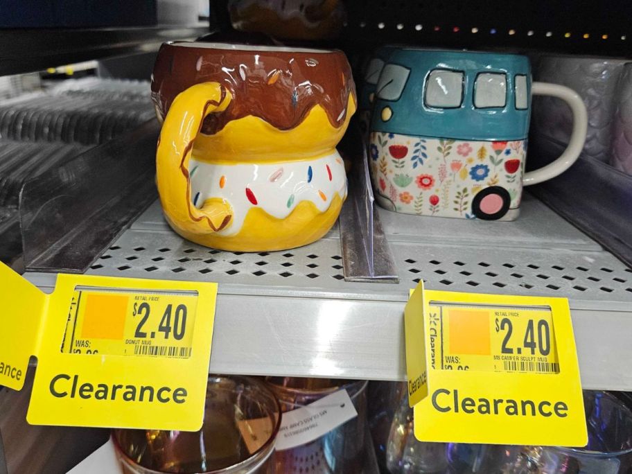 a donut coffee mug and a VW van coffee mug on a store shelf