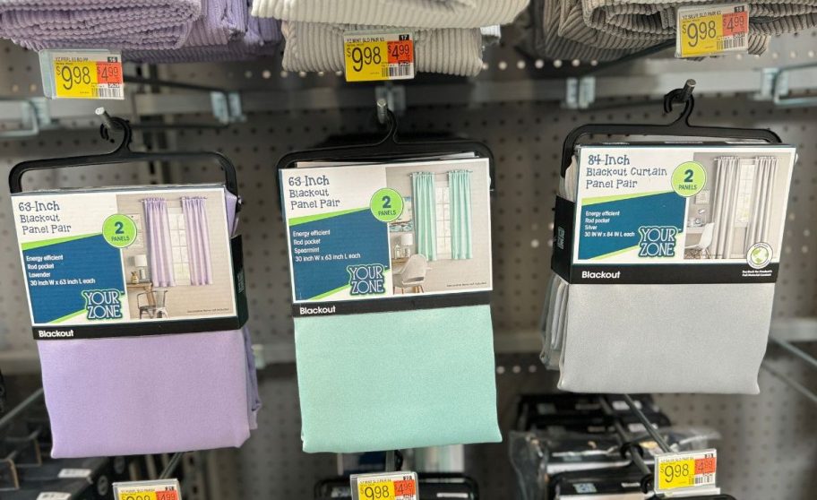 walmart Your Zone Solid Blackout Rod Pocket Curtain Panel Pairs hanging on racks in store