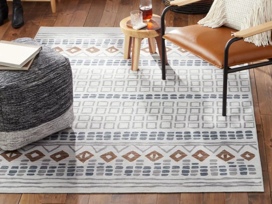 ran, grey and brown geometric pattern rug on a floor in a living room