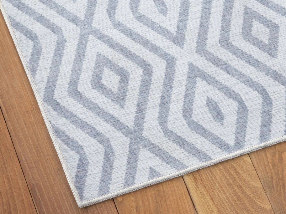 light grey and white diamond pattern rug on a floor