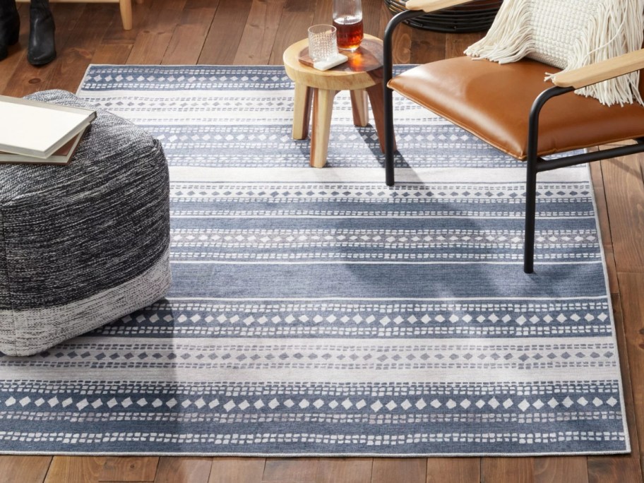dark grey and white geometric stripe pattern rug on a living room floor
