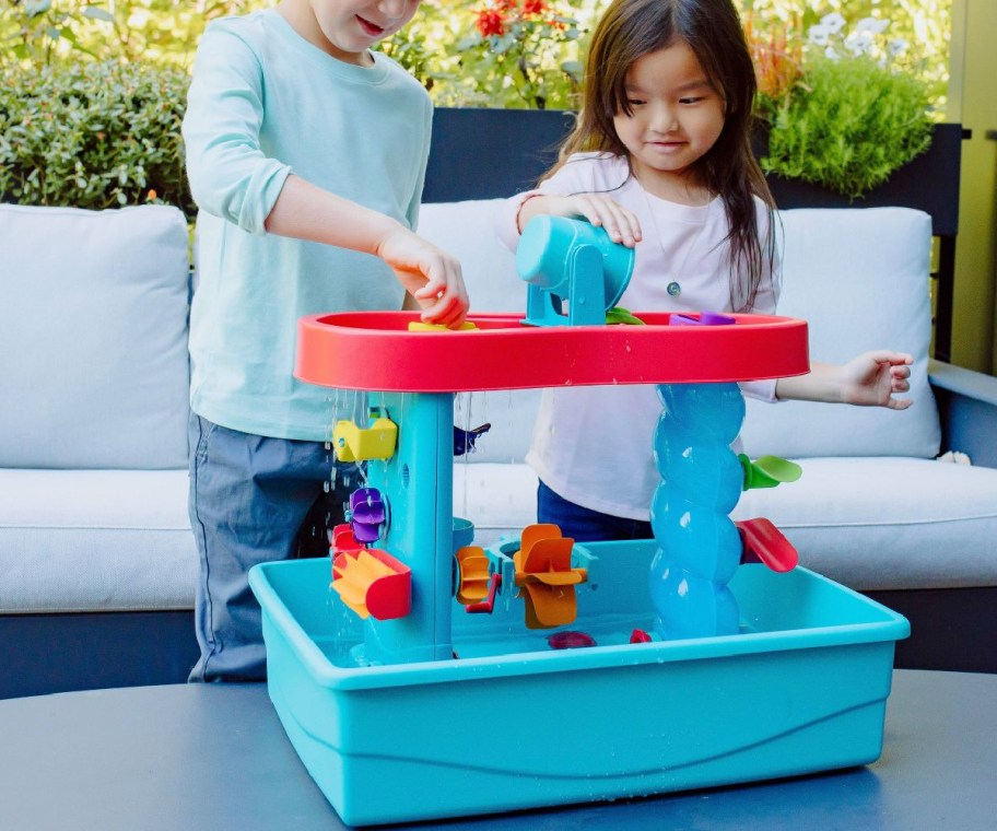 two kids playing at tabletop water table