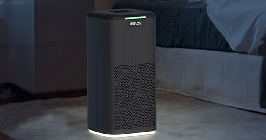 gray air purifier in darkliving room with night light on 