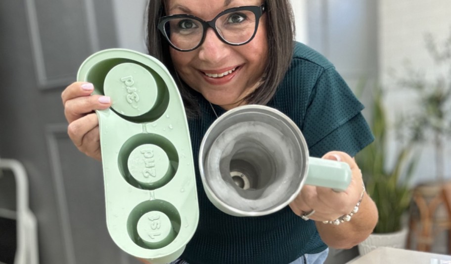 woman holding silicone ice mold maker in ahnd with her cup as well