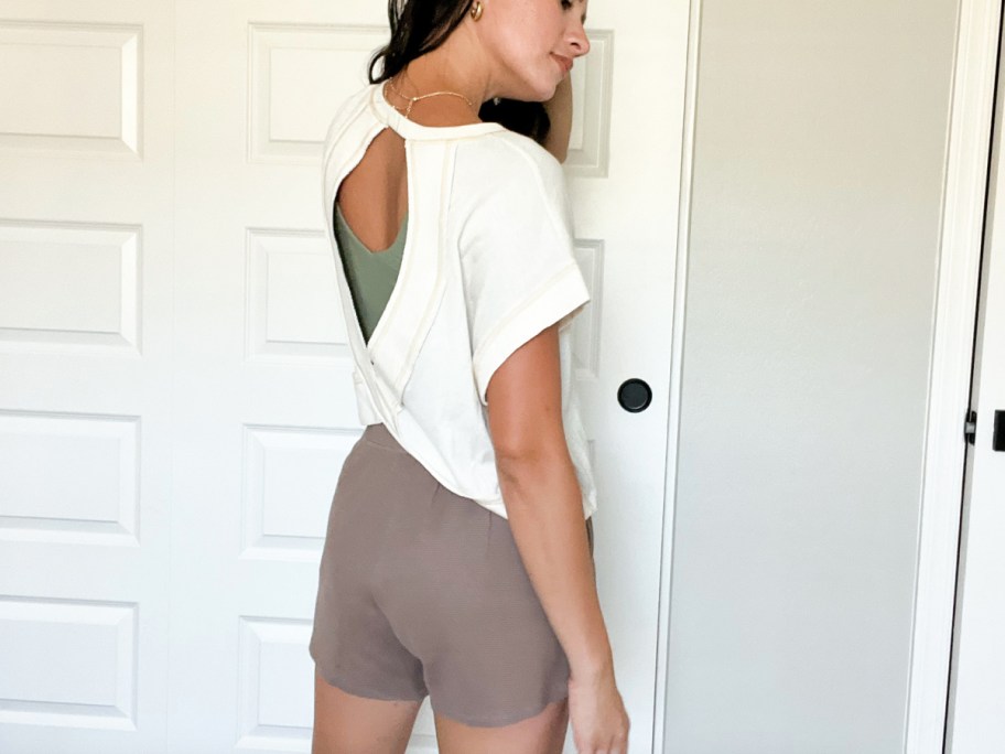 woman wearing shirt, shorts showing the backs