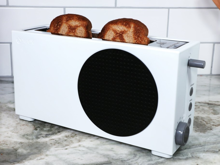 xbox toaster with bread sticking out of it on the countert