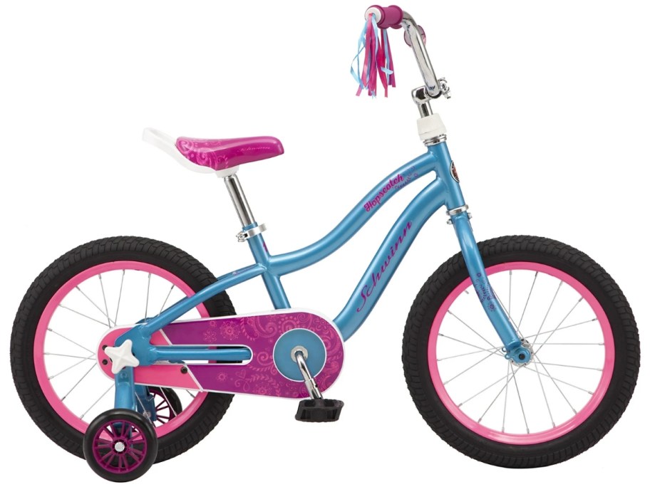 a girl's pink, blue and white bike with black wheels and streamers on the handlebars