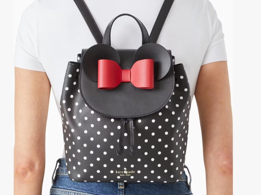 woman wearing a black and white polka dot Kate Spade Minnie Mouse backpack