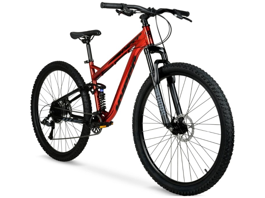 an adult's red and black mountain bike with large wheels