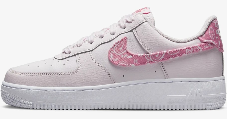 women' Nike Air Force 1 shoe in light pink with a pink paisley swoosh
