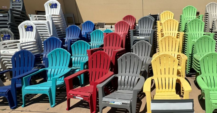 Adams PATIO Stackable Charcoal Plastic Frame Stationary Adirondack Chair with Slat Seat on display outside store