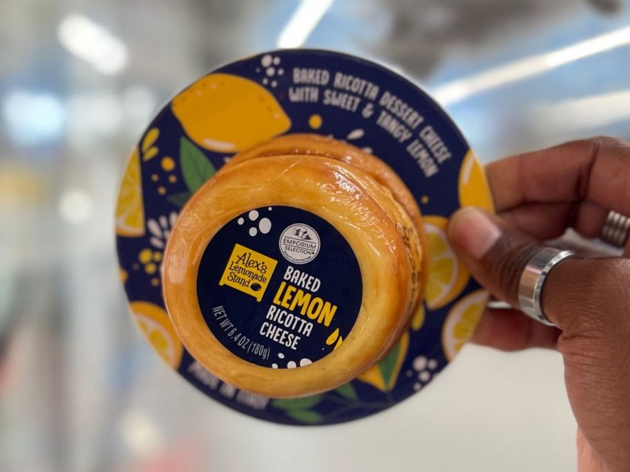 Hand holding up a pack of Aldi Baked lemon Ricotta Cheese from Aldi