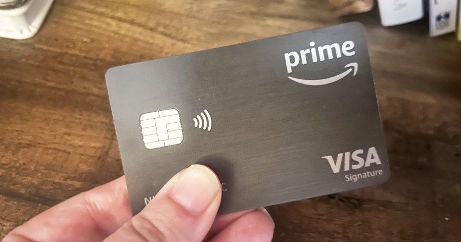 hand holding a black Amazon Prime Visa credit card