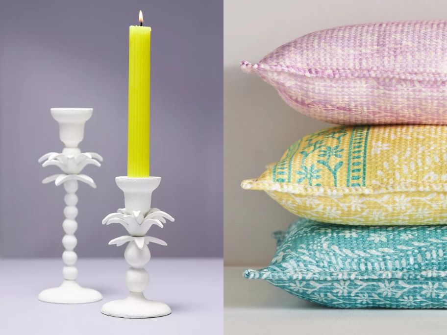 A yellow candle in a holder and pillows