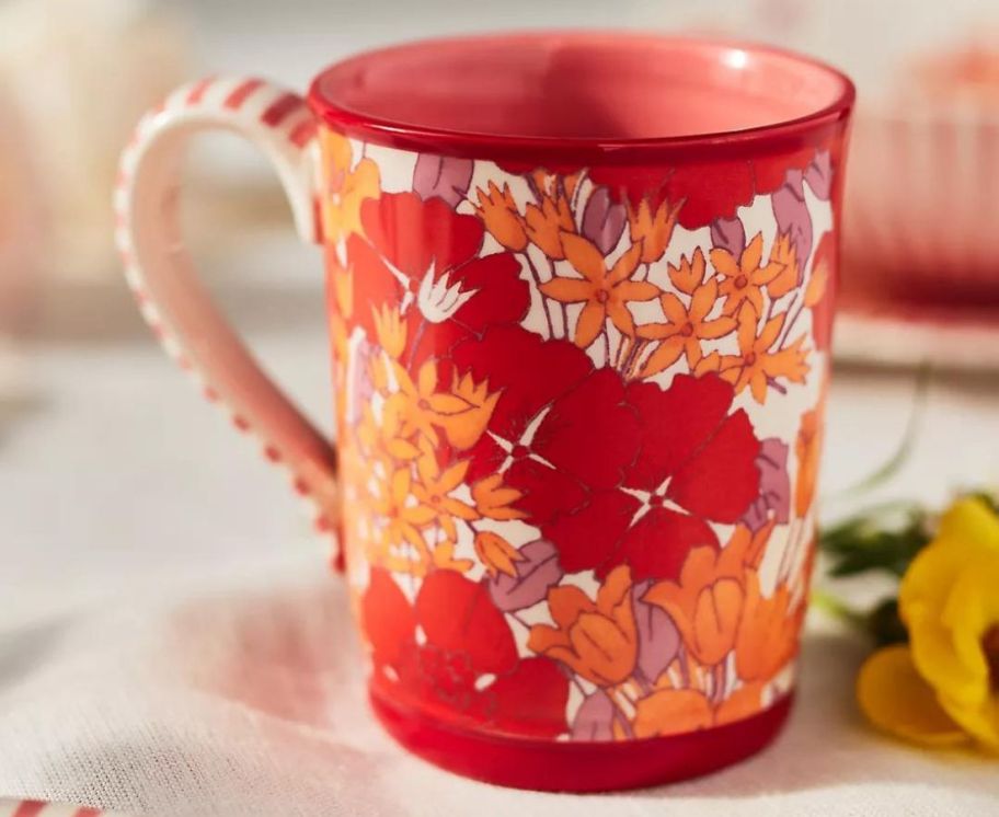 A red and orange floral mug