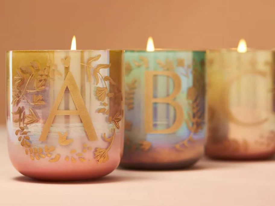 3 candles with the letters 