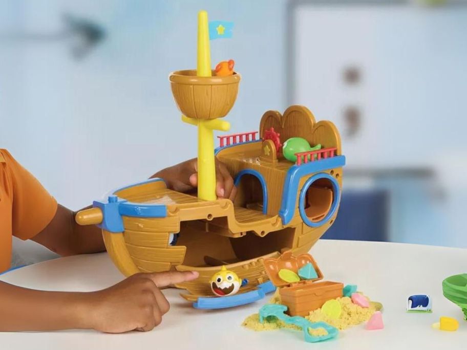 kid playing with Baby Shark Ultimate Shipwreck Play Set