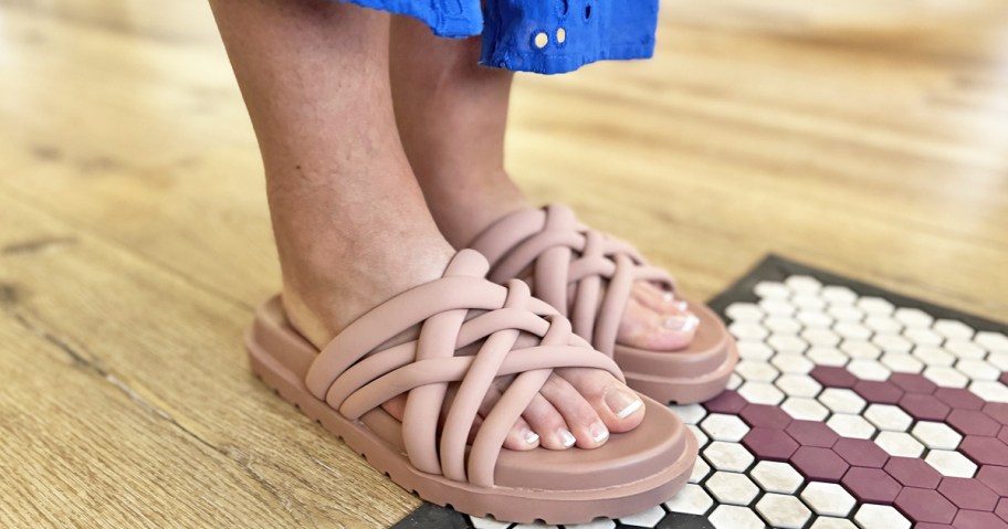 woman wearing a pair of pink woven slides