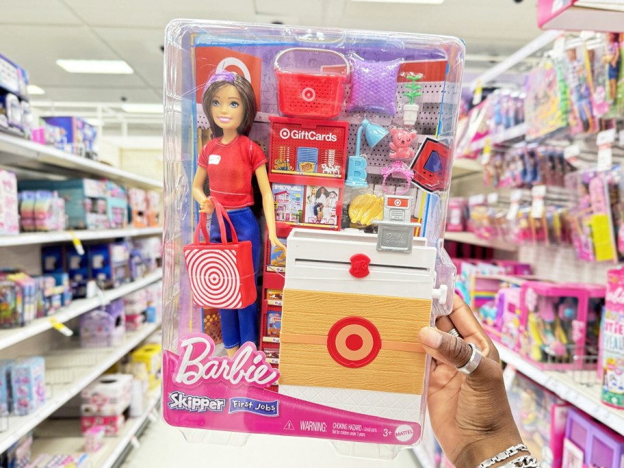 hand holding up target barbie doll playset in store