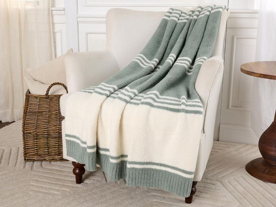 A barefoot Dreams blanket draped over a chair