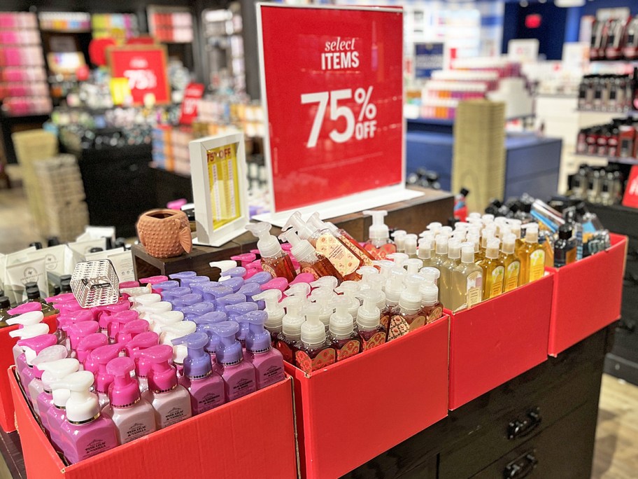 red boxes of Bath & Body Works Hand Soaps with 75% off sale sign
