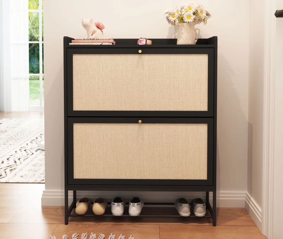 a black and natural rattan shoe cabinet