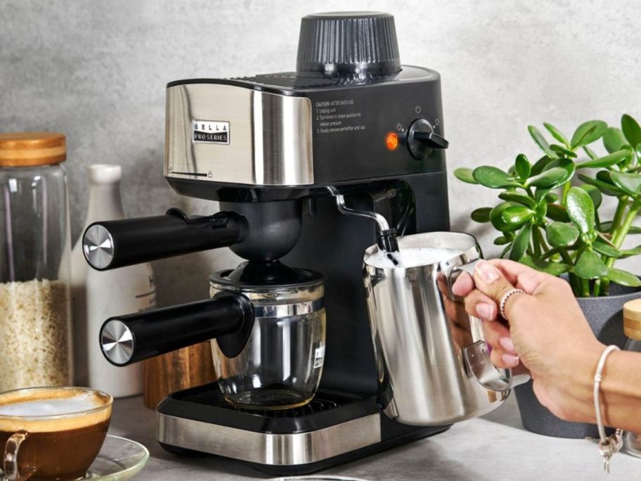 An espresso machine on a counter surrounded by coffee items