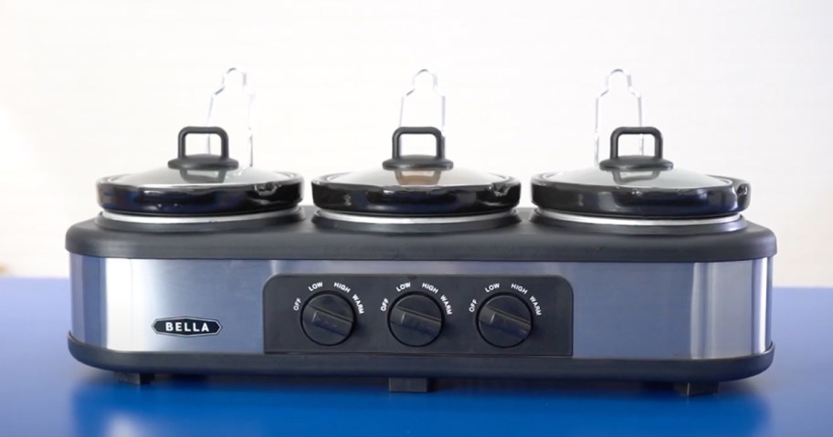 triple slow cooker on blue counter