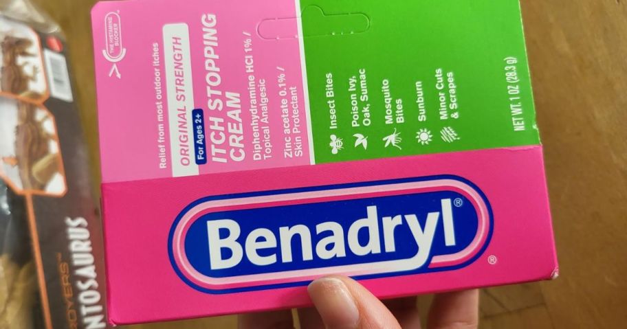 hand holding a box of Benadryl Cream