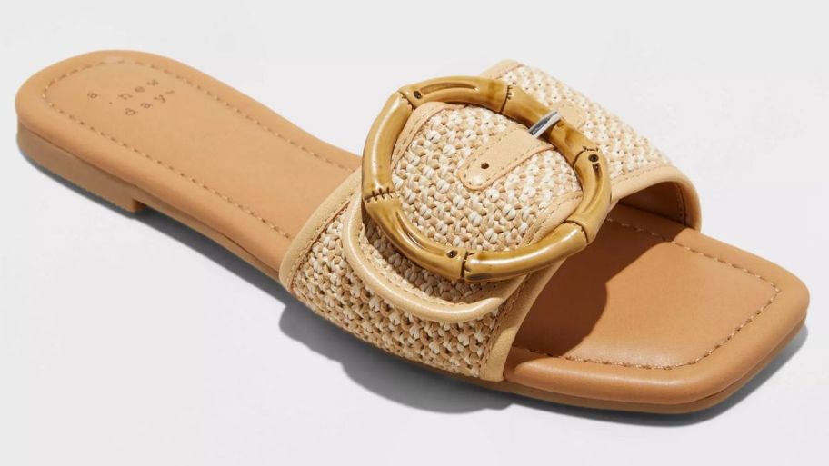 a flat slide sandal with a bamboo buckle