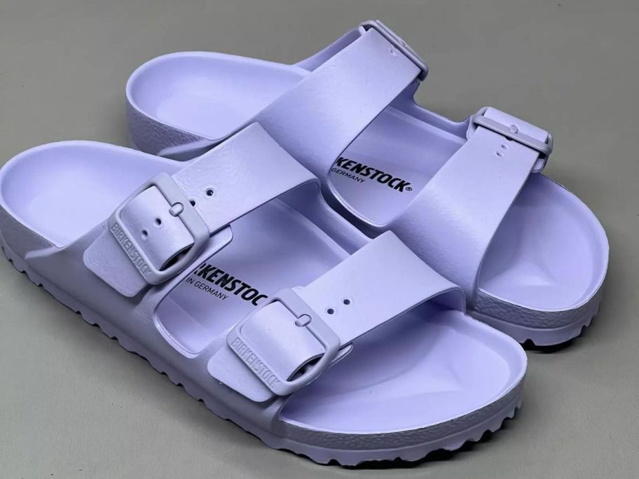 A pair of Birkenstock Arizona Eva Sandals in Purple Fog 