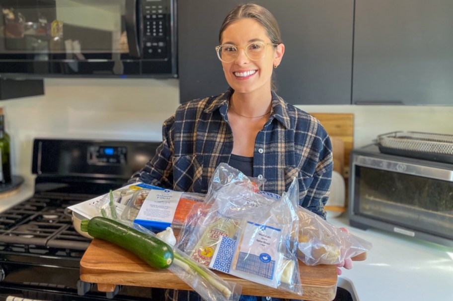 Woman with her Blue Apron order in the kitchen