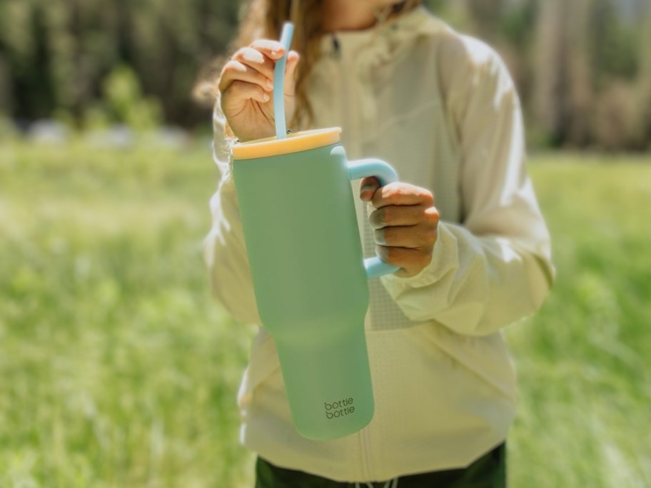 Green Bottle Woman holding 40 oz tumbler