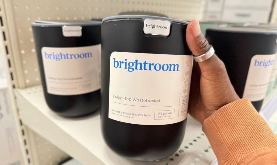 a small black round desktop trash can