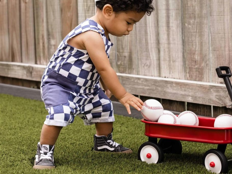 boy wearing Burt's Bees Baby Check Organic Cotton Baby Romper outside next to wagon