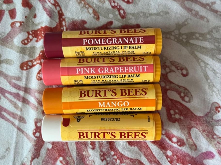 Burt's Bees Lip Balm 4-pack on a bed