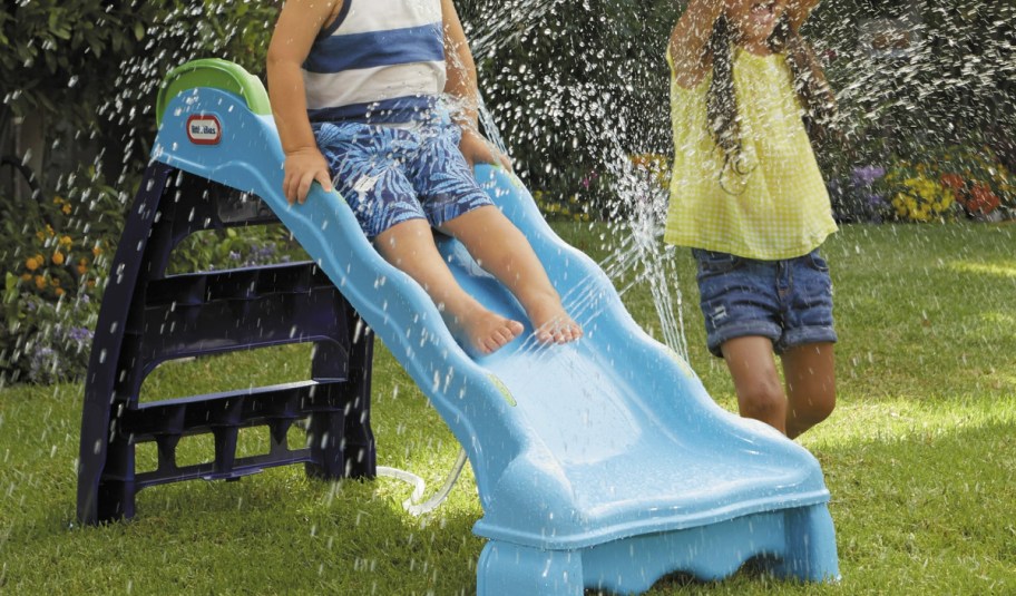 Child using the foldable slide with water