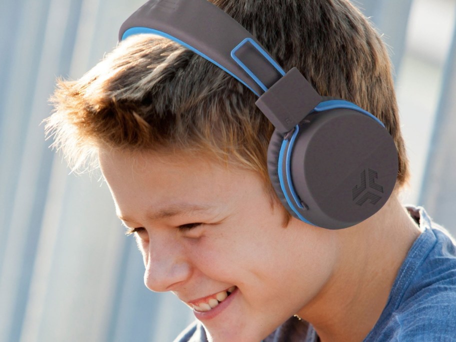 Child wearing overhead headphones in blue and gray