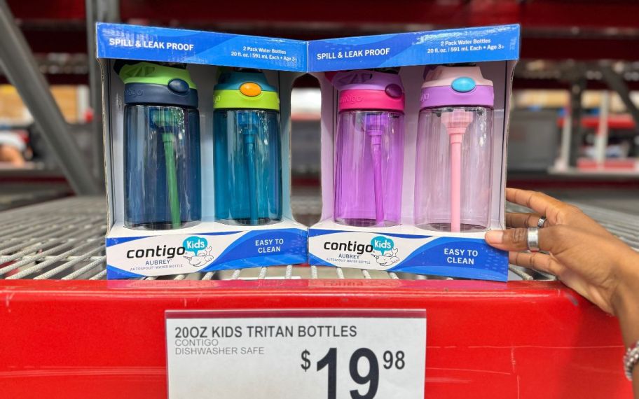 Two 2-packs of 20oz plastic water bottles on a store shelf