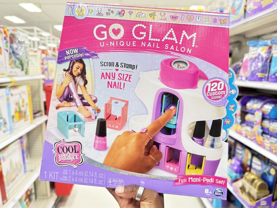 hand holding up Cool Maker Go Glam U-Nique Nail Salon toy in store
