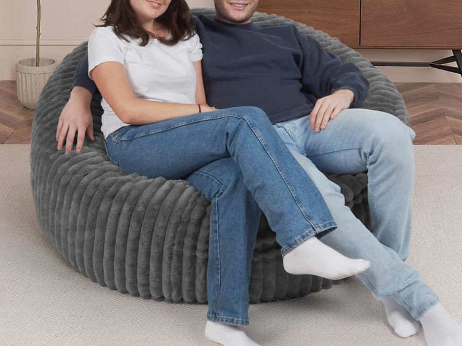 A couple sitting on a costco jumbo lounger