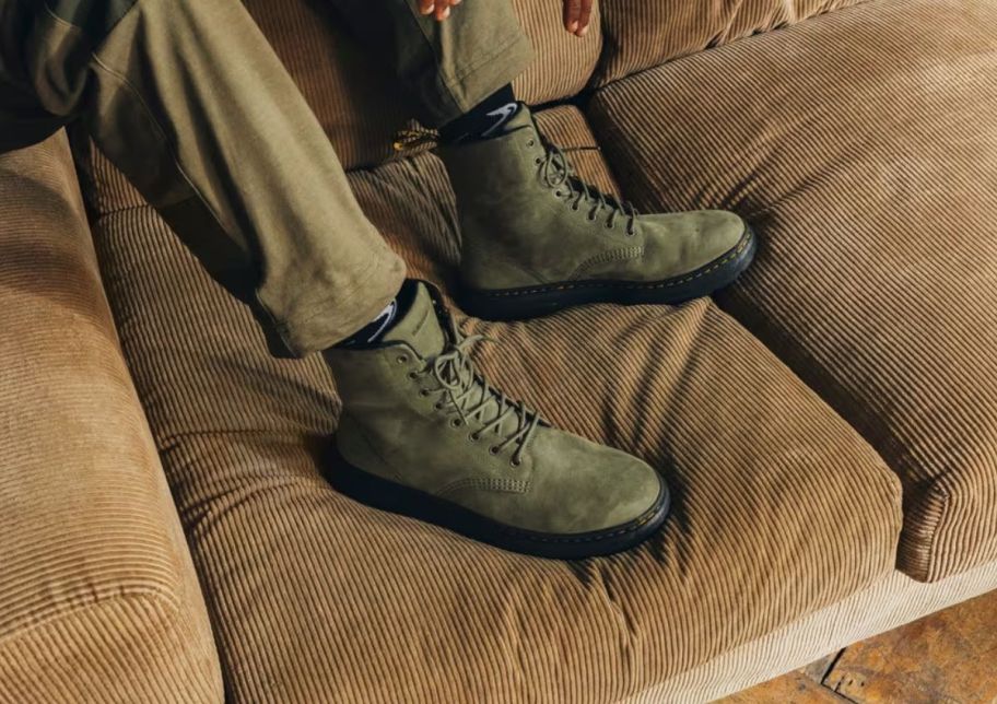 a model wearing a pair of olive green lace upboots